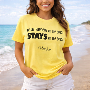 Woman wearing a yellow t-shirt with beach-themed text on a beach