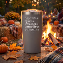 Grey 20oz engraved Adventure tumbler engraved with “Hayrides Leaves Sweaters Campfires Pumpkins” in a dusk autumn campfire…