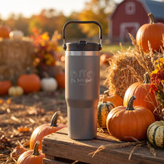 Gray 30oz engraved Saratoga tumbler engraved with “It's Fall Y'all Pumpkins” in a golden-hour pumpkin patch lifestyle