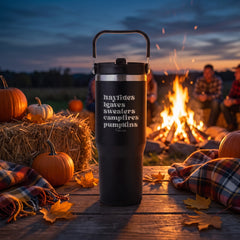 Black 30oz engraved Saratoga tumbler engraved with “Hayrides Leaves Sweaters Campfires Pumpkins” in a dusk autumn campfire…