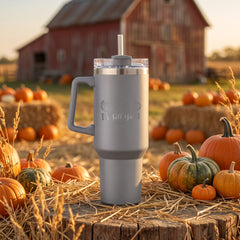 Grey 40oz engraved travel tumbler engraved with “It's Fall Y'all Pumpkins” in a golden-hour pumpkin patch lifestyle