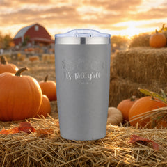 Grey 20oz engraved Adventure tumbler engraved with “It's Fall Y'all Pumpkins” in a golden-hour pumpkin patch lifestyle